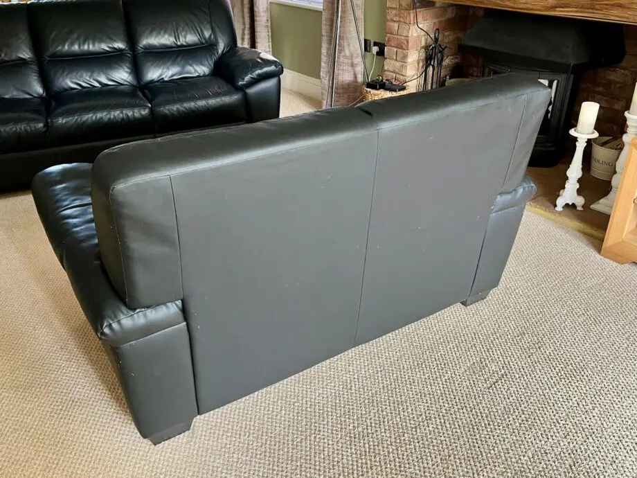 DFS Black Leather 3 and 2 Seater Sofas with matching footstool
