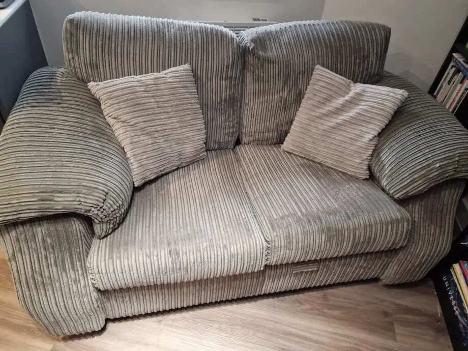 Grey 2 Seater Sofa with 2 pillows and Unused Fabric Care Kit