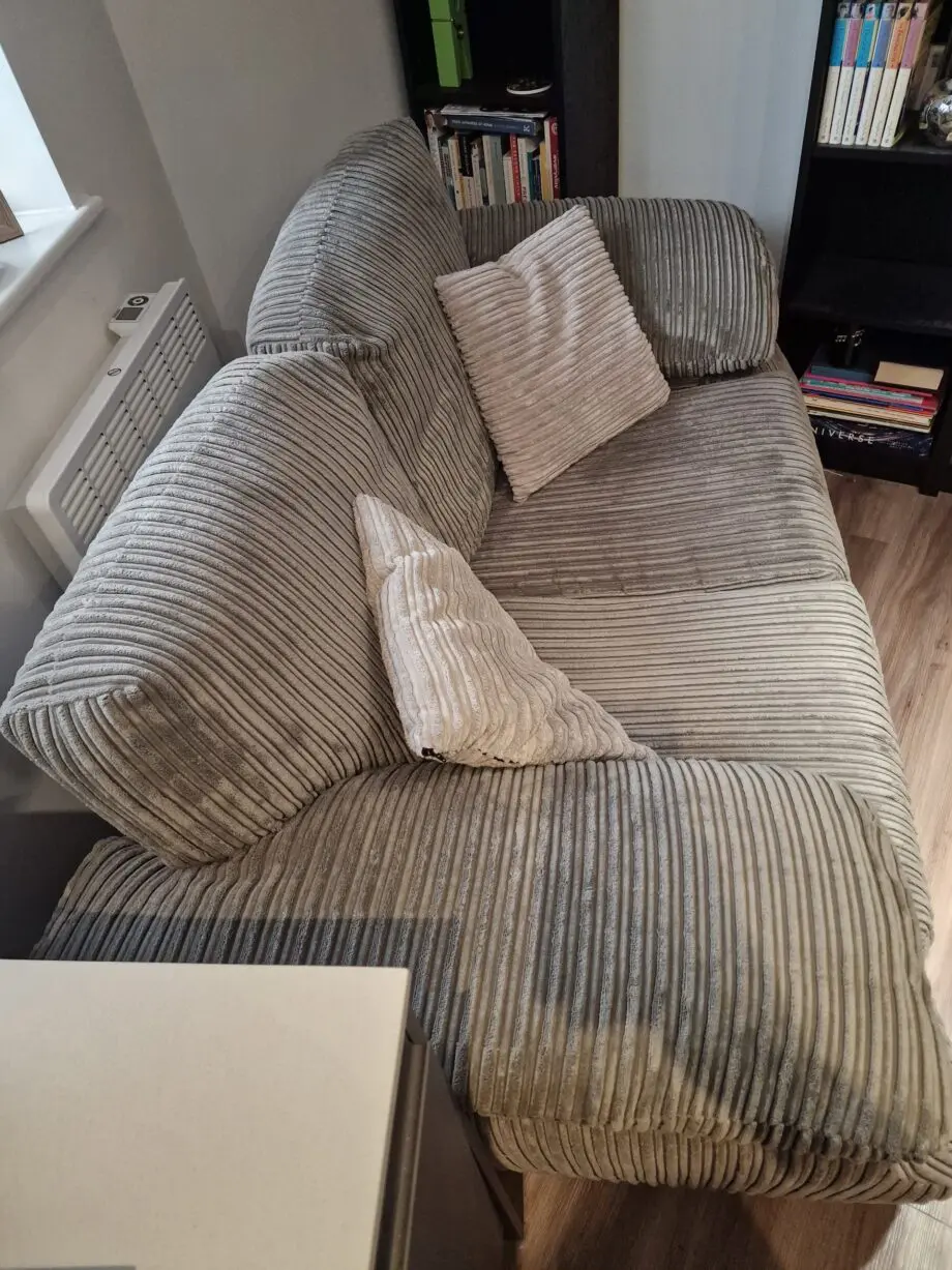 Grey 2 Seater Sofa with 2 pillows and Unused Fabric Care Kit