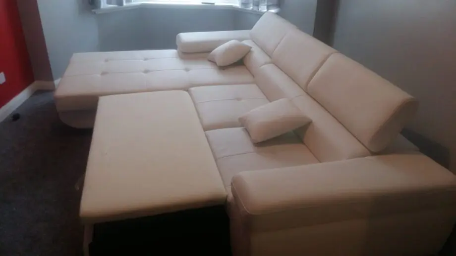 White leather corner sofa bed