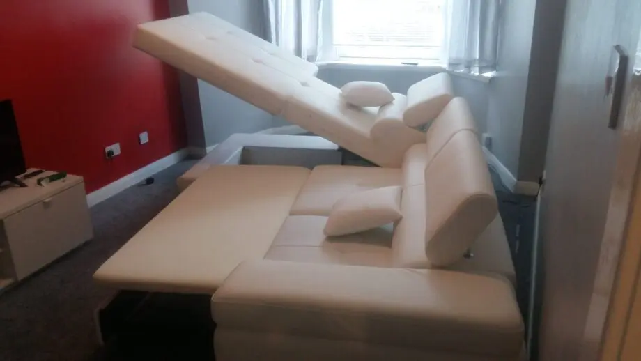 White leather corner sofa bed