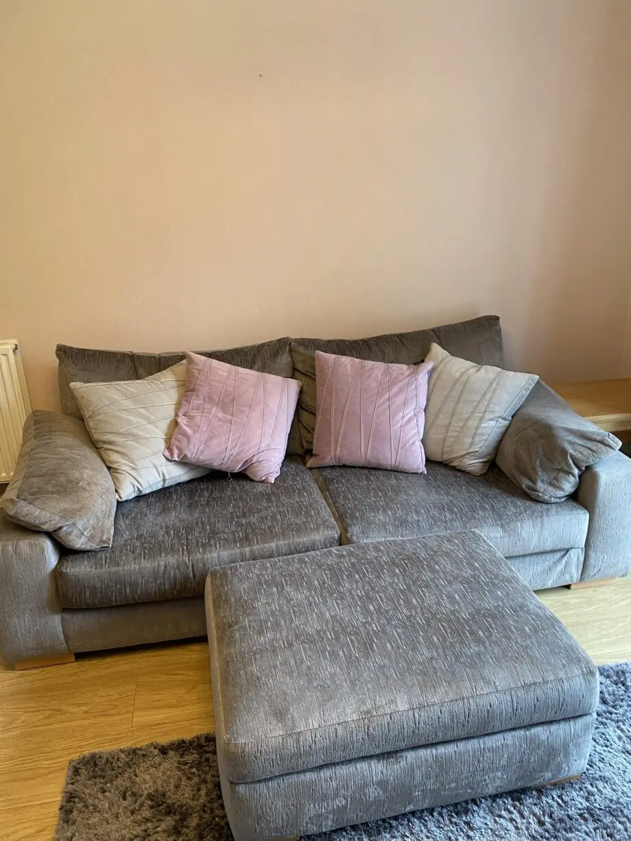 Large grey sofa with ottoman footstool