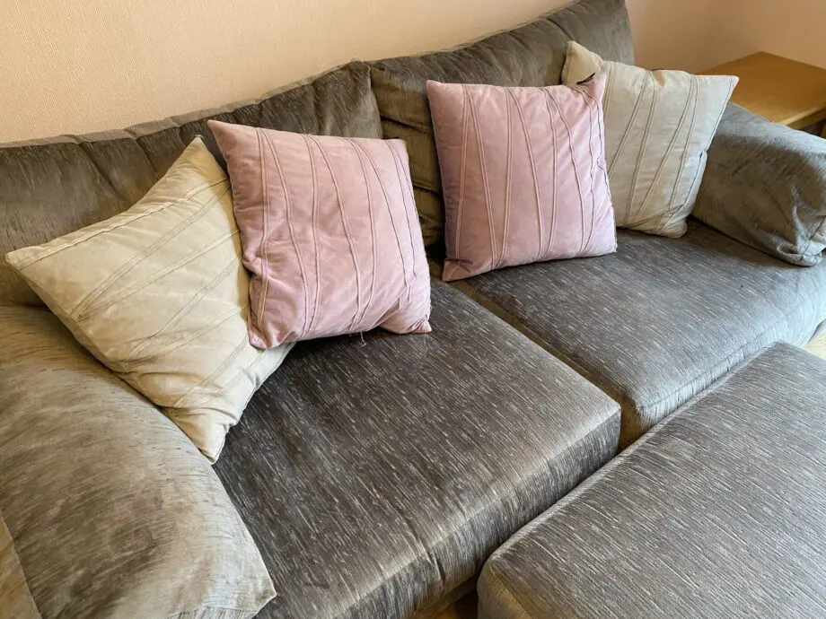 Large grey sofa with ottoman footstool