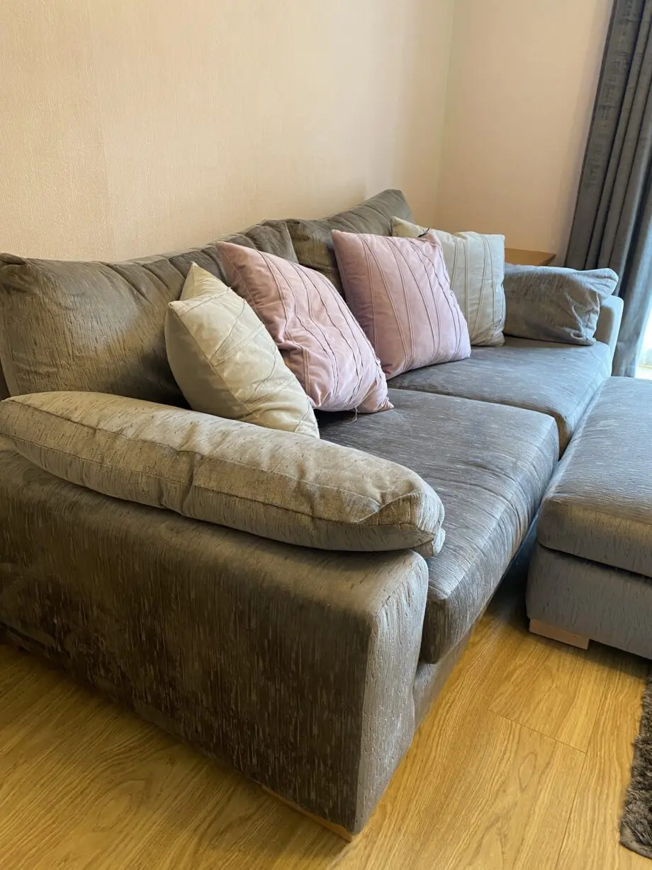 Large grey sofa with ottoman footstool