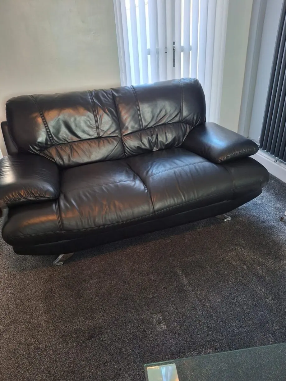 Black sofa and armchair with foot rest