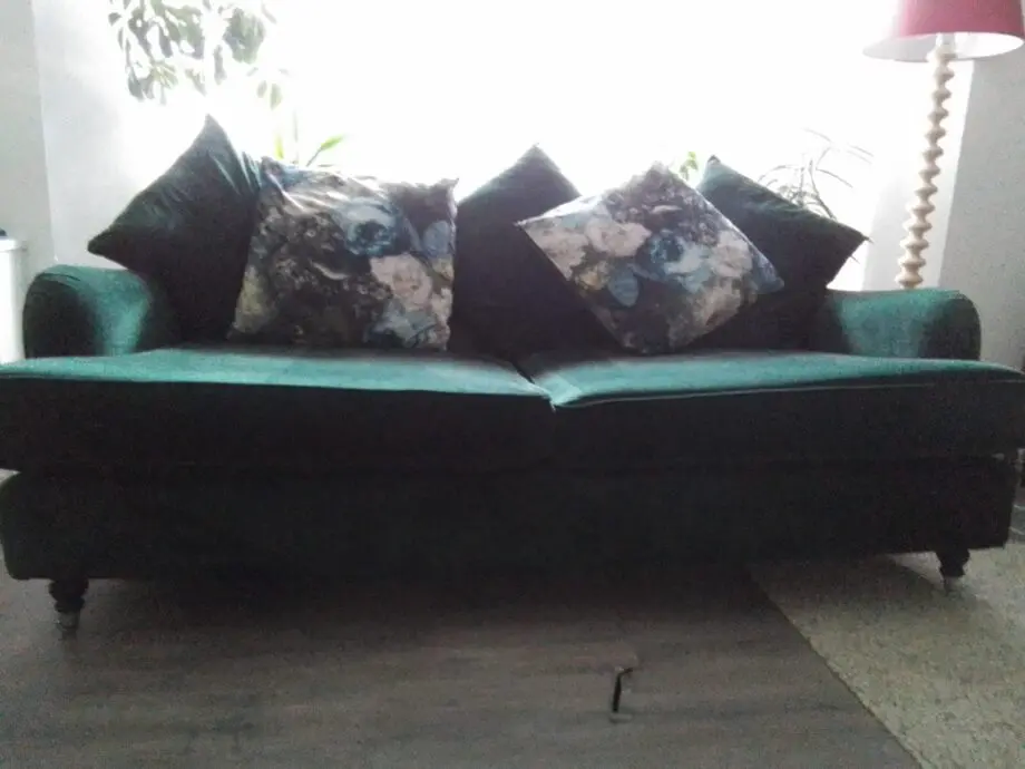 Large three seater forest green velvet sofa