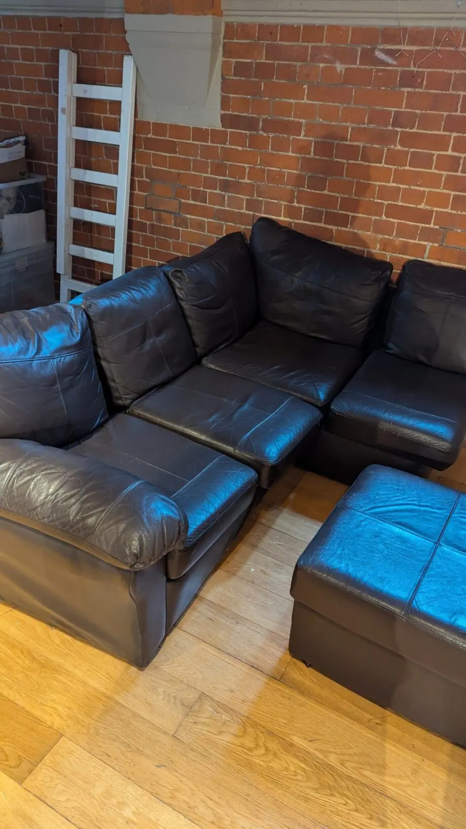 Small L-shaped brown leatherette sofa