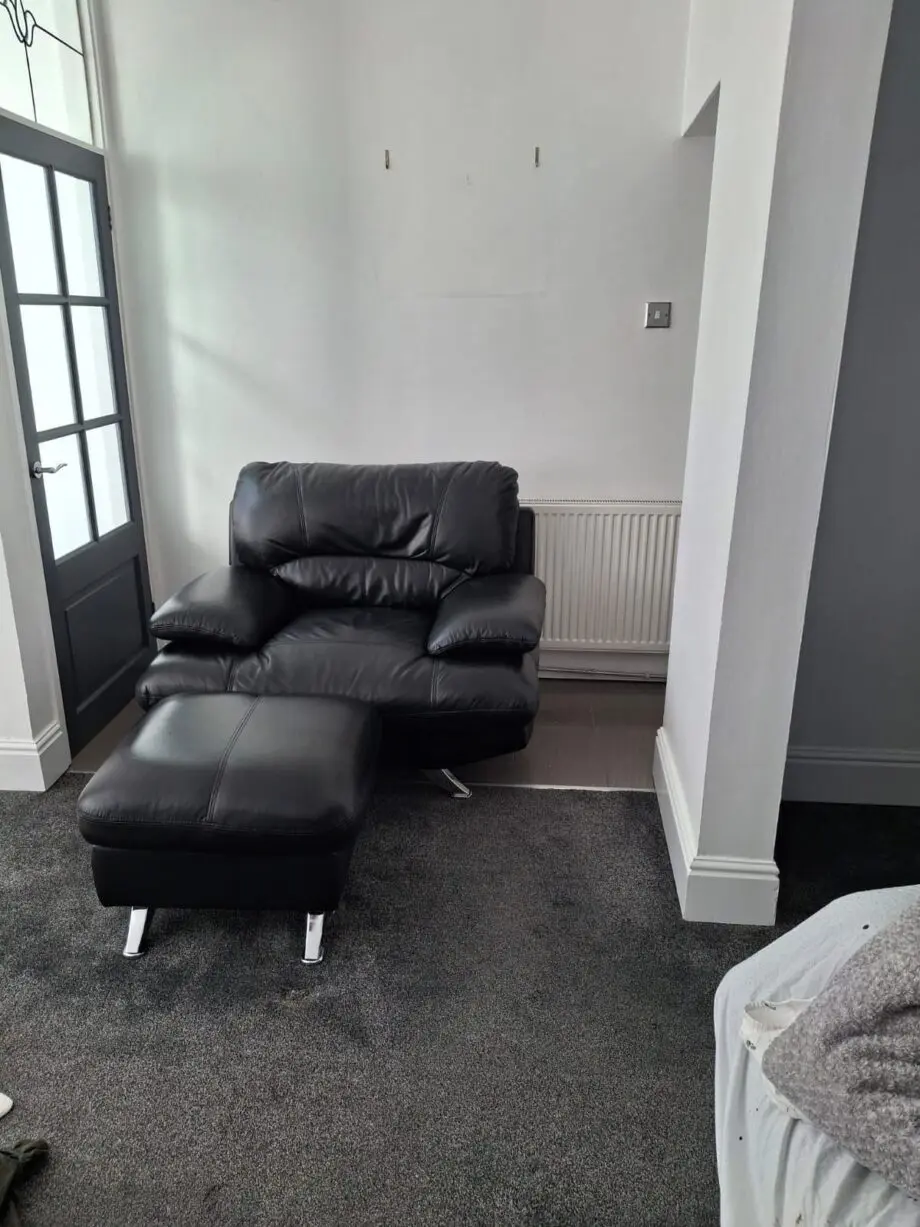 Black sofa and armchair with foot rest