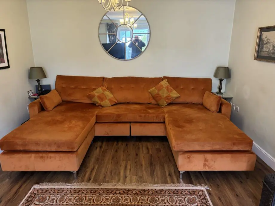 Nearly new burnt orange U shaped sofa