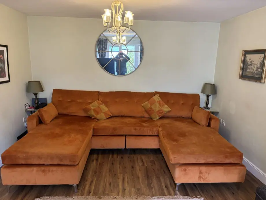 Nearly new burnt orange U shaped sofa