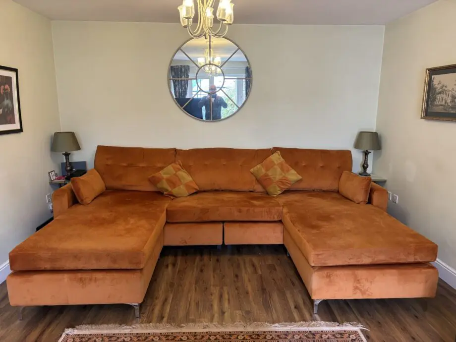 Nearly new burnt orange U shaped sofa