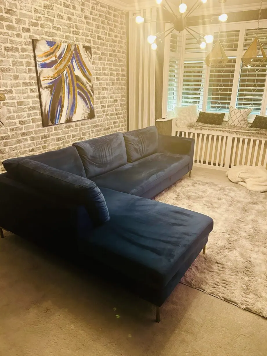 Blue velvet chaise corner sofa with ottoman