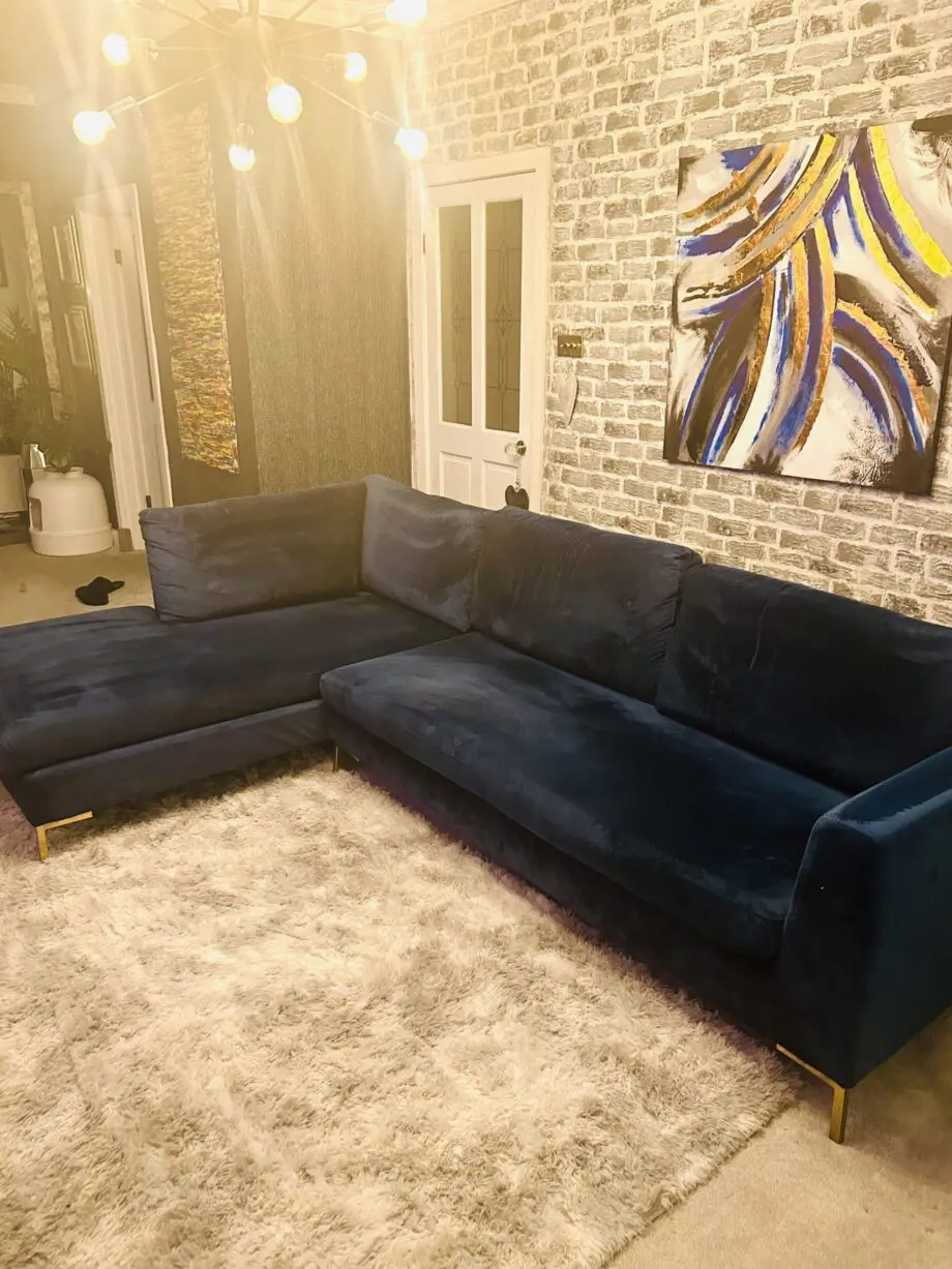 Blue velvet chaise corner sofa with ottoman