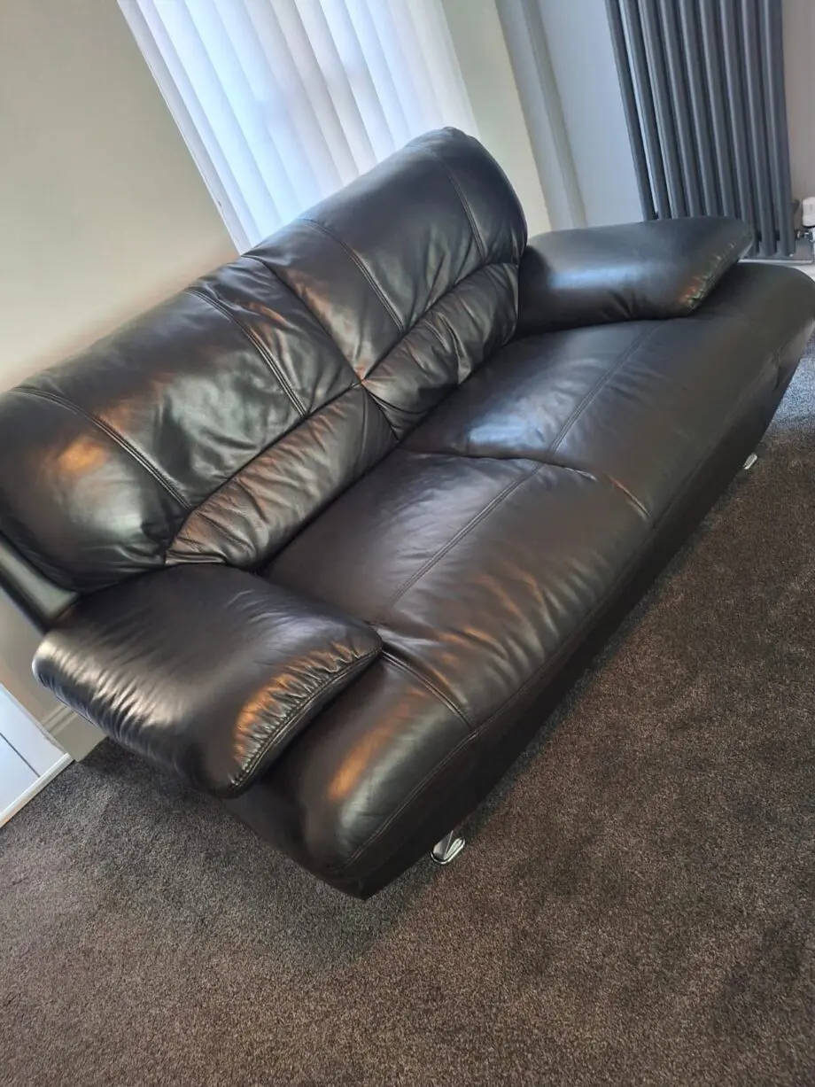 Black sofa and armchair with foot rest