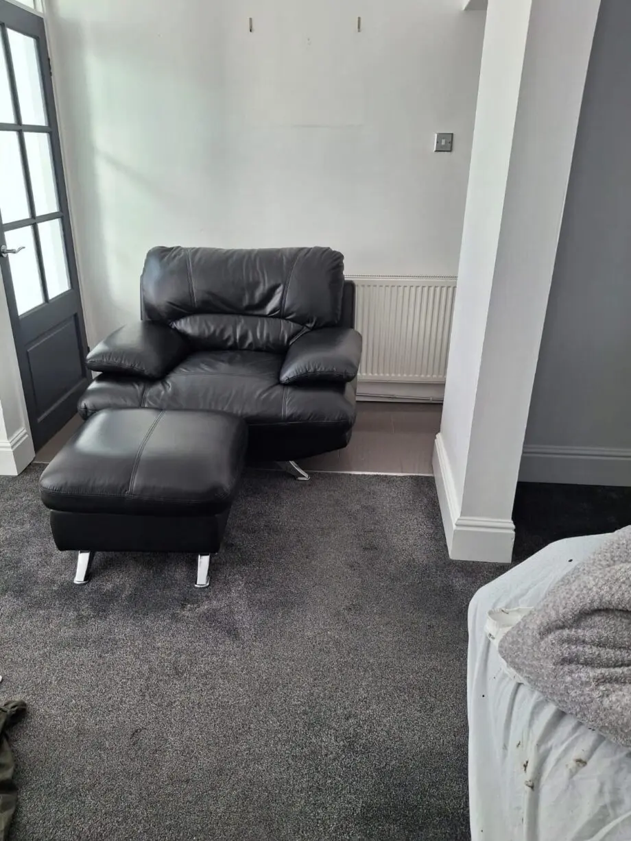 Black sofa and armchair with foot rest