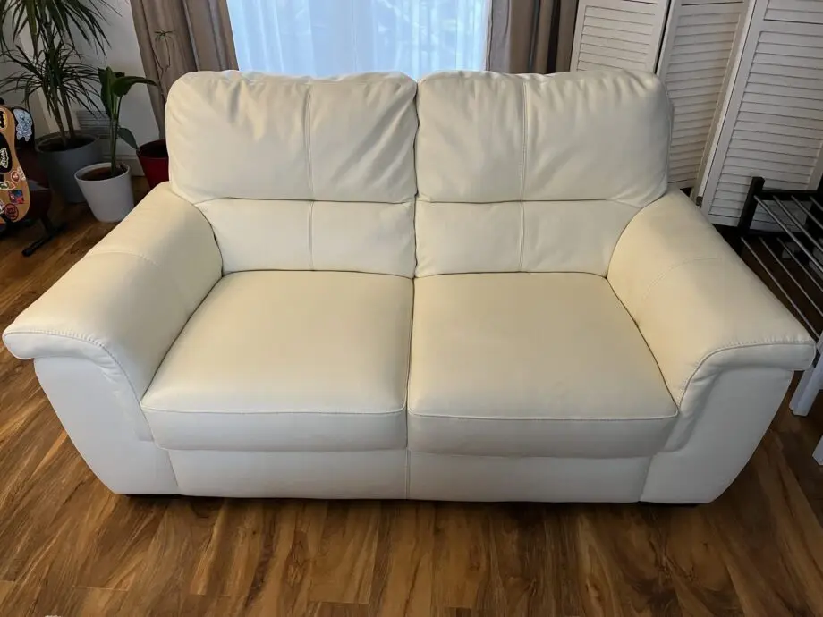 Two cream leather sofas.