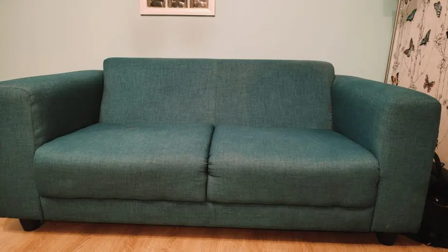 Two Teal 2- seater sofas with 2 60*60 cushions each.