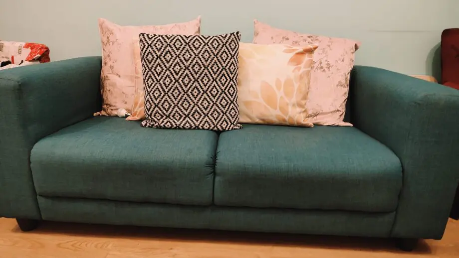 Two Teal 2- seater sofas with 2 60*60 cushions each.