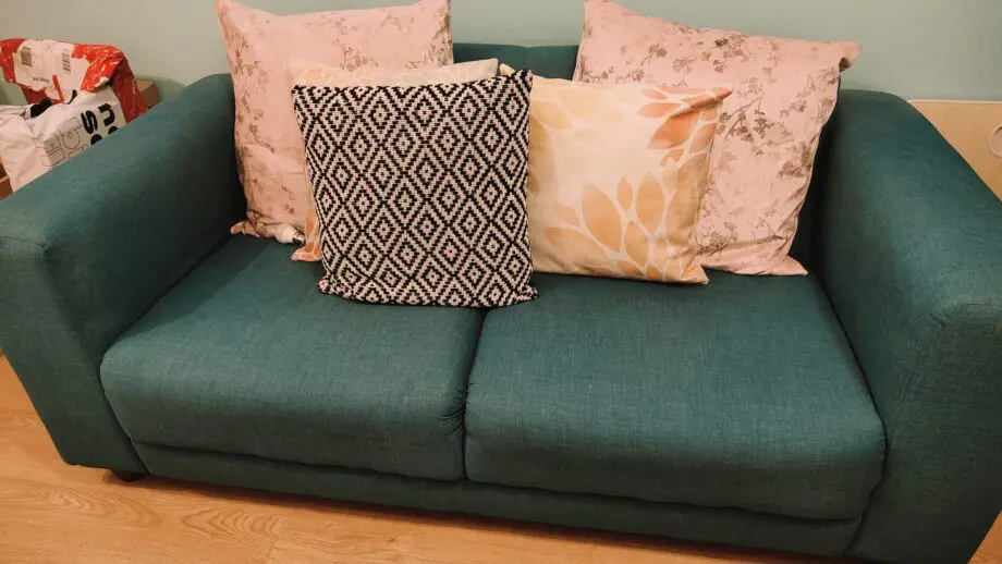Two Teal 2- seater sofas with 2 60*60 cushions each.