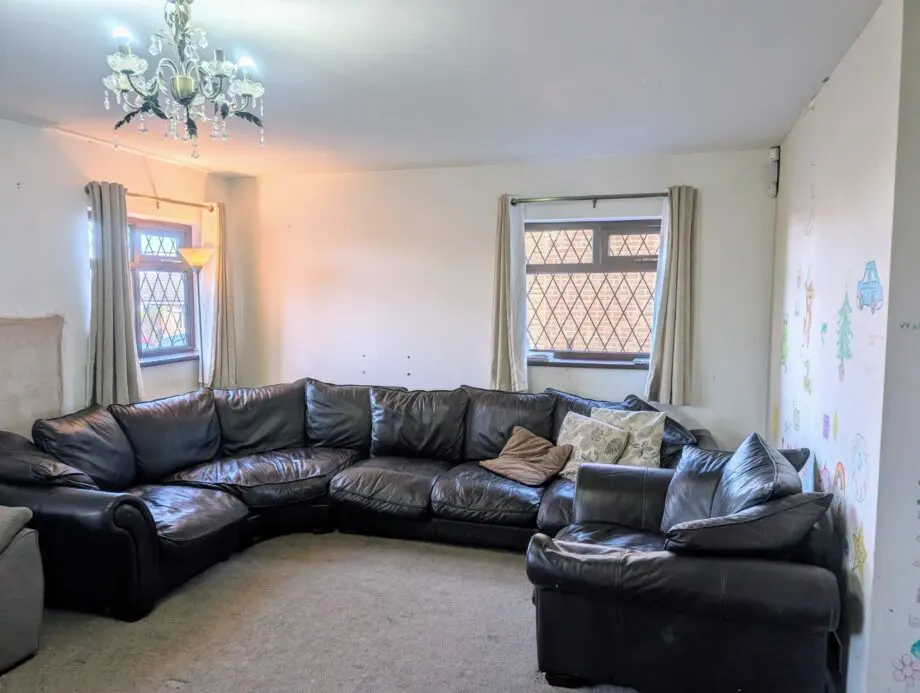 Black leather 5-6 seater sofa plus single sofa and large foot stool.