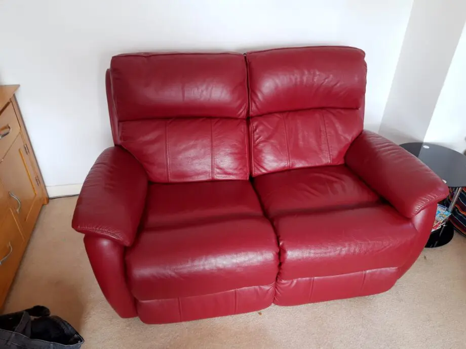 Two Navona reclining sofas, dark red, leather