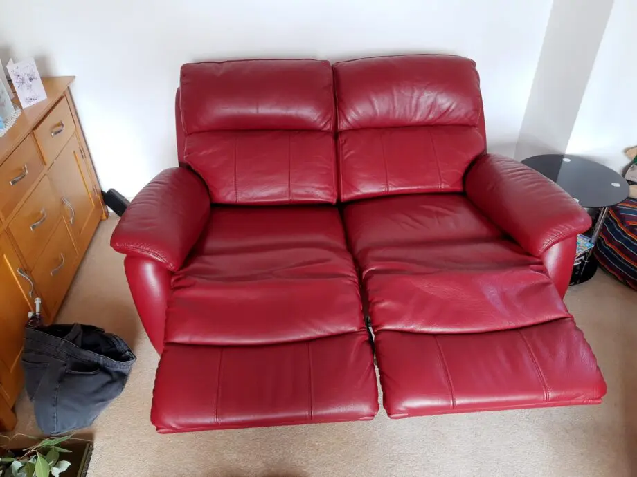 Two Navona reclining sofas, dark red, leather