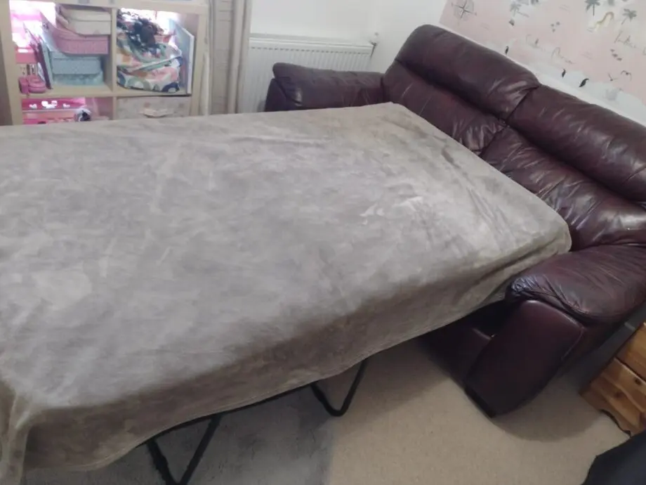 DFS two-seater sofa bed, oxblood leather