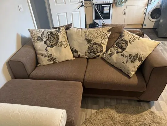 Brown 3 seater and poufe