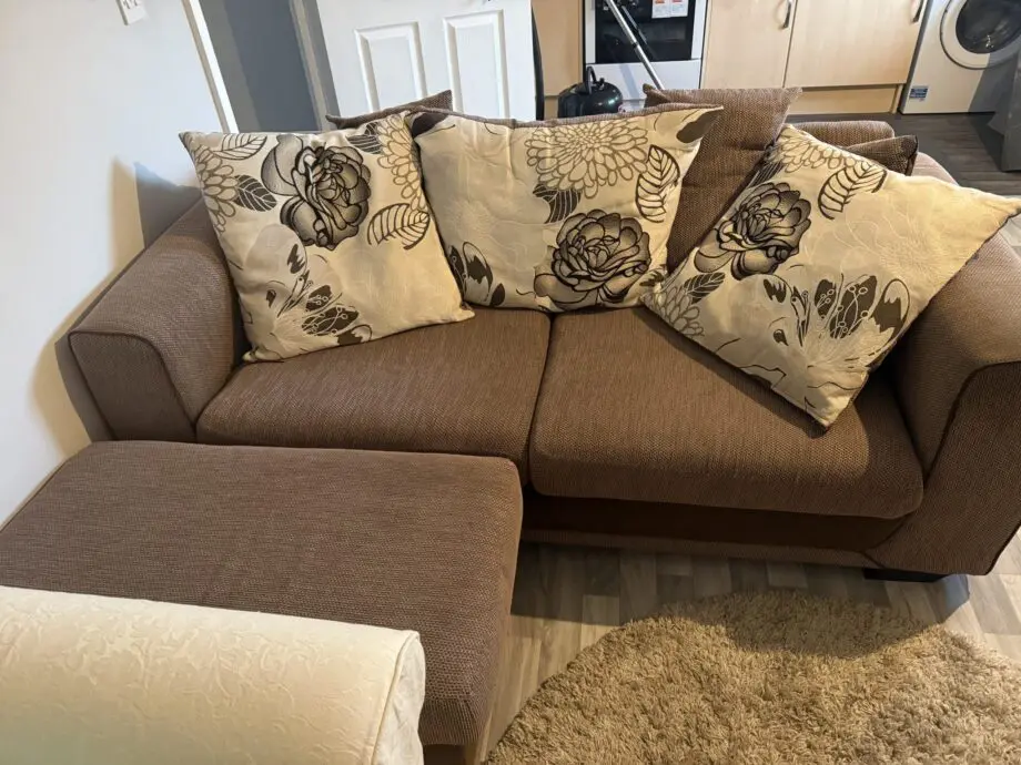 Brown 3 seater and poufe