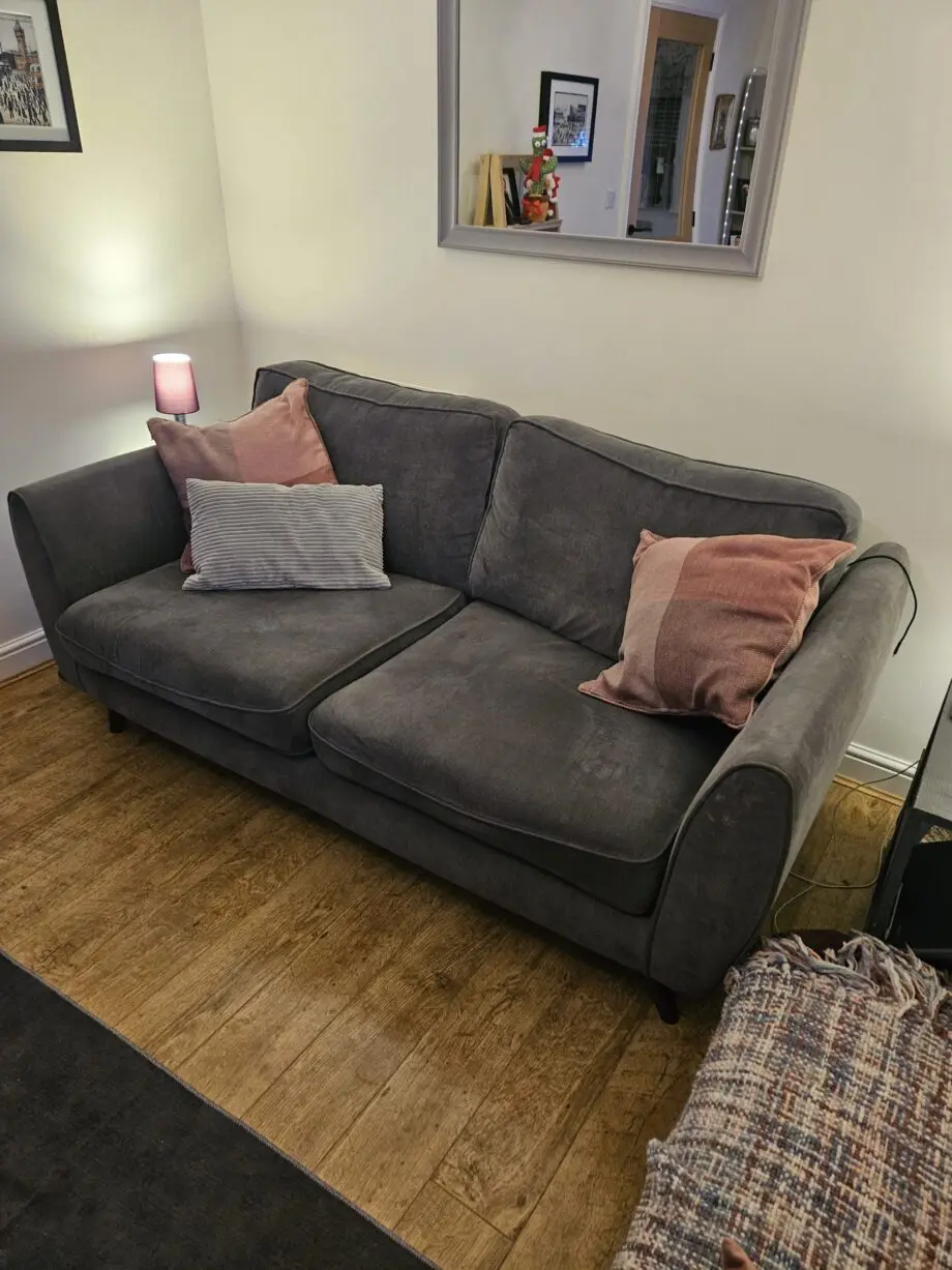Lovely very clean 2 setter grey sofa with 2 pink/plum cushions