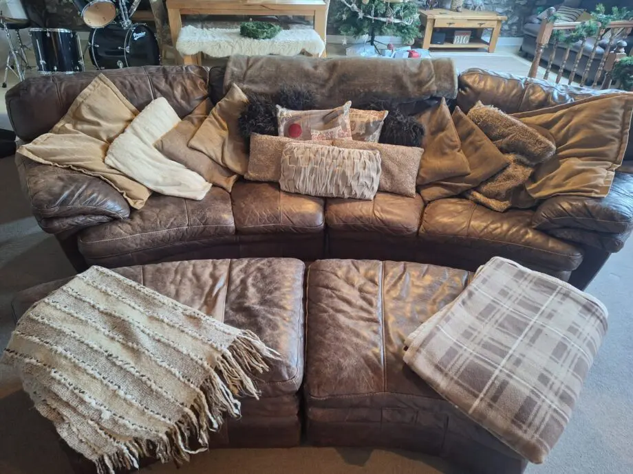 Large curved leather sofa + chairs + footstools