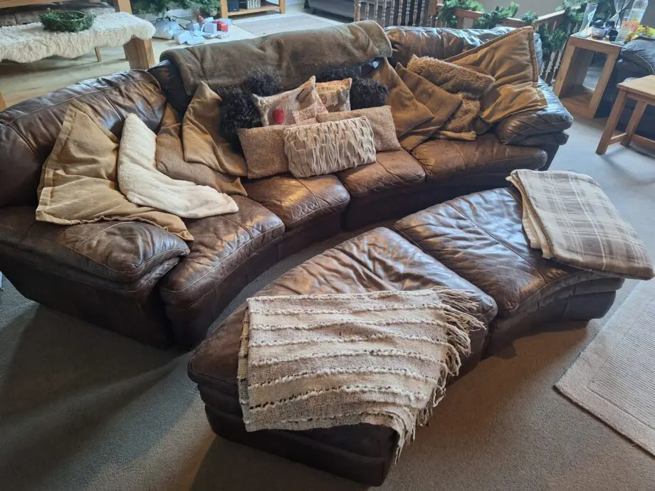Large curved leather sofa + chairs + footstools