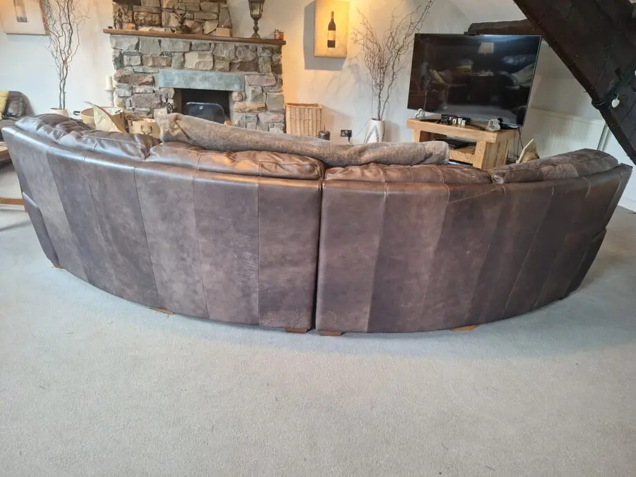 Large curved leather sofa + chairs + footstools