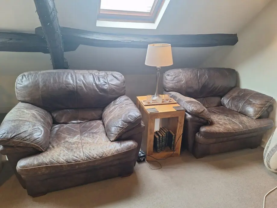 Large curved leather sofa + chairs + footstools