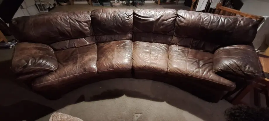 Large curved leather sofa + chairs + footstools