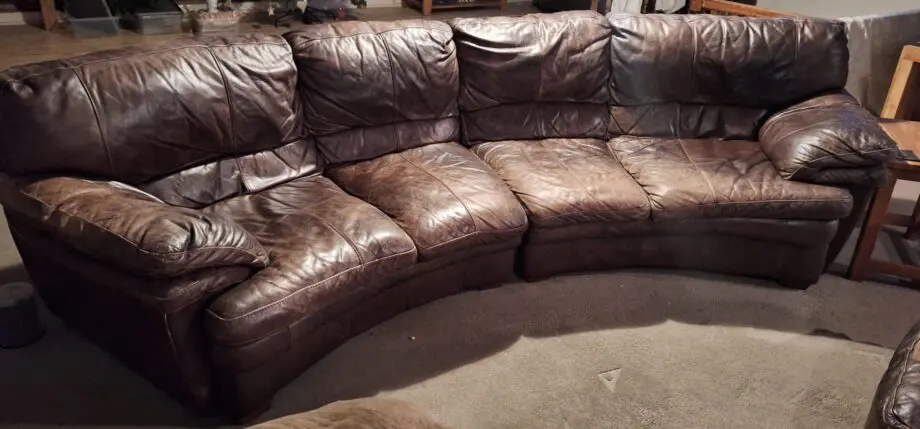 Large curved leather sofa + chairs + footstools