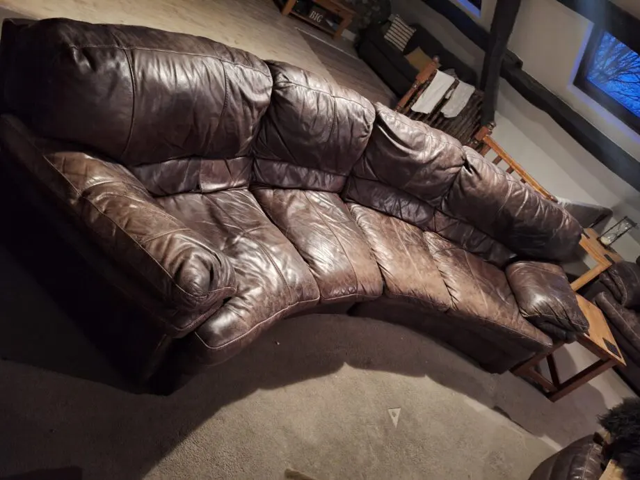 Large curved leather sofa + chairs + footstools
