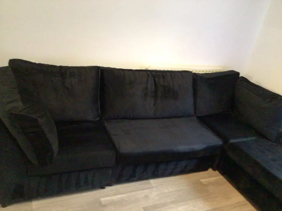 Black plush corner sofa