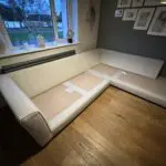 Corner sofa, accent chair and round footstool.