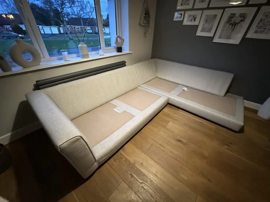 Corner sofa, accent chair and round footstool.