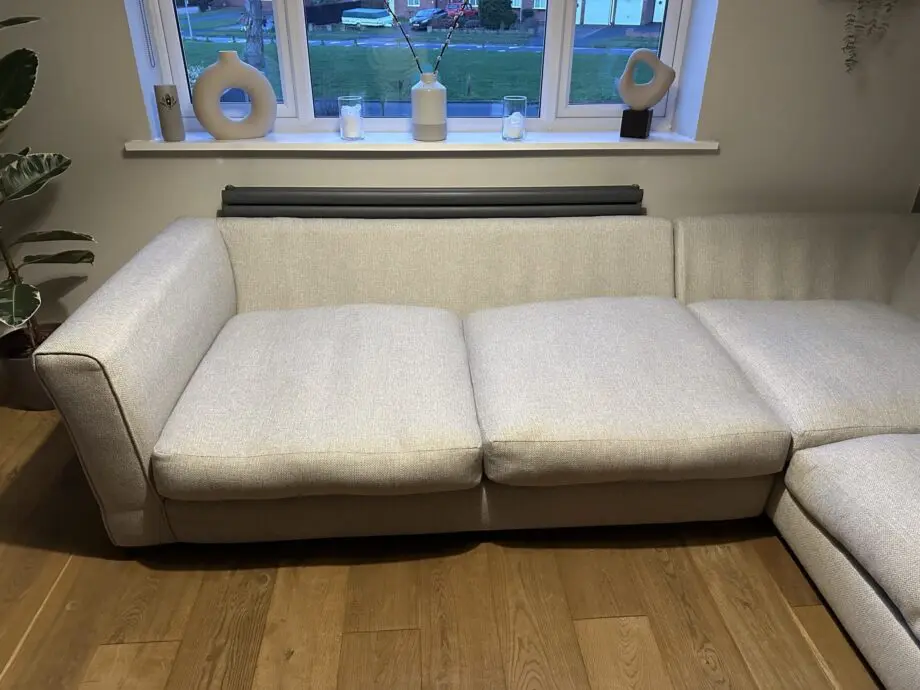 Corner sofa, accent chair and round footstool.