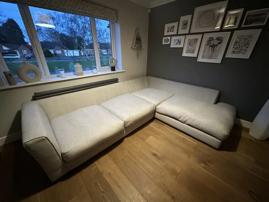 Corner sofa, accent chair and round footstool.