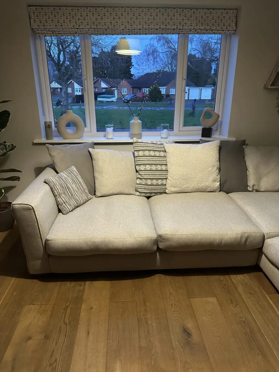 Corner sofa, accent chair and round footstool.