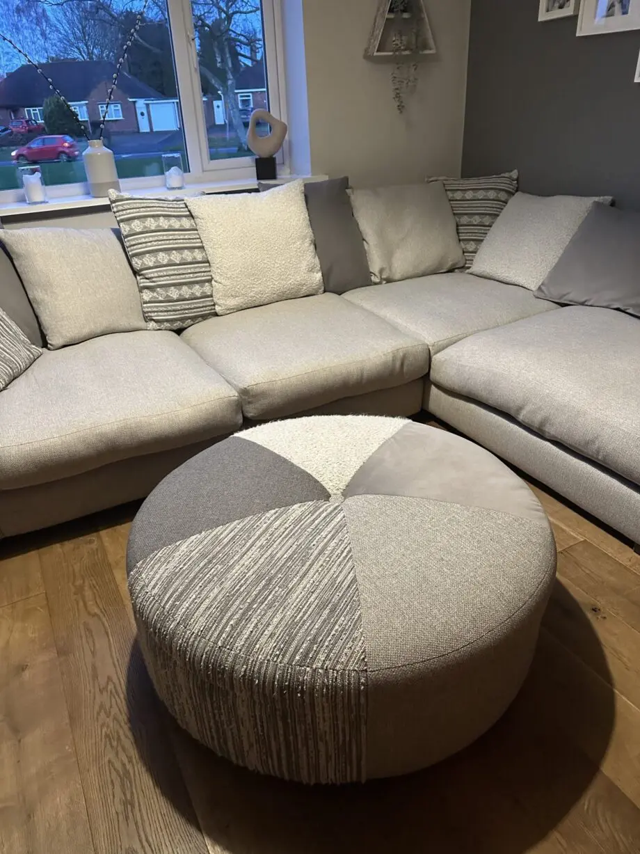 Corner sofa, accent chair and round footstool.