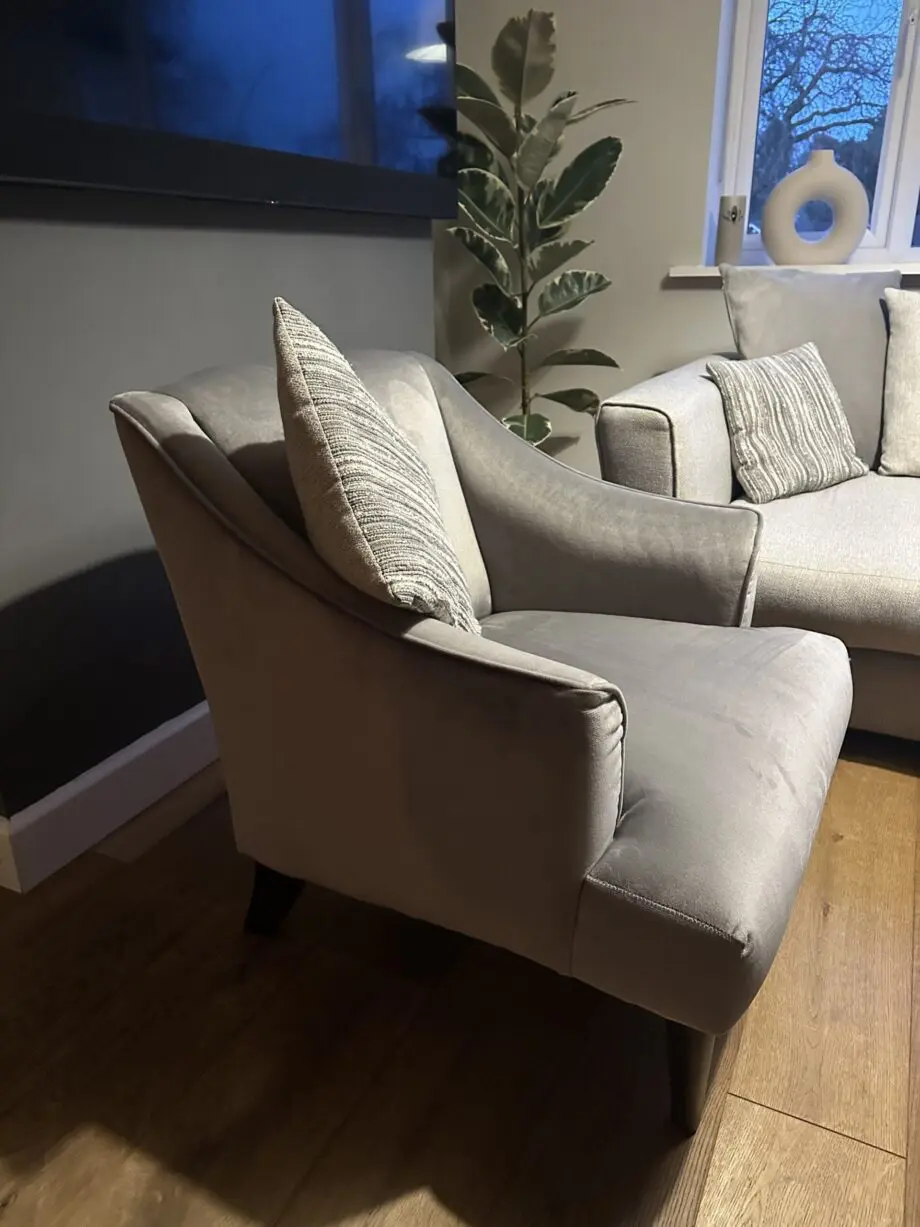 Corner sofa, accent chair and round footstool.
