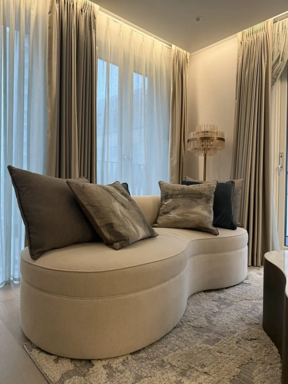 “Elegant Beige Curved Sofa - Modern Design with Plush Comfort”