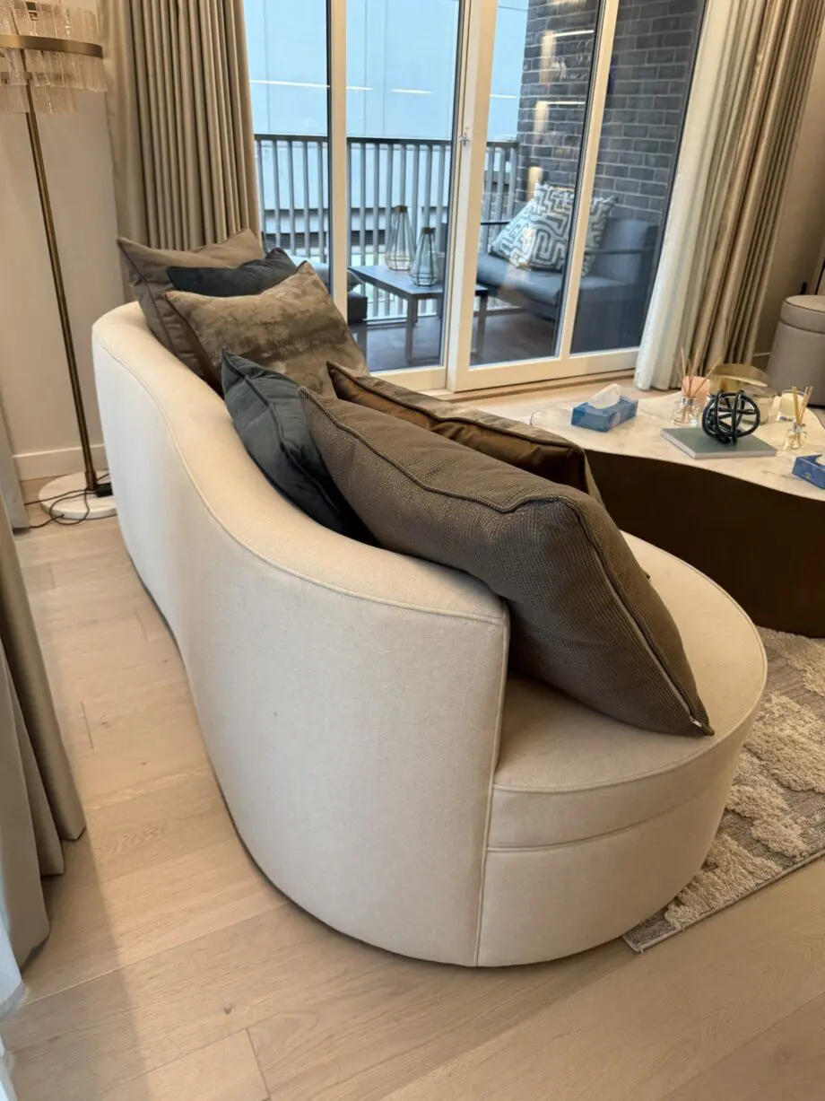 “Elegant Beige Curved Sofa - Modern Design with Plush Comfort”