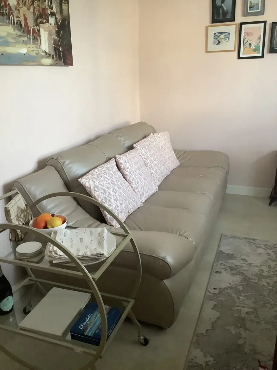 Quality neutral colour leather sofa and matching snuggle chair(Sterling Home)