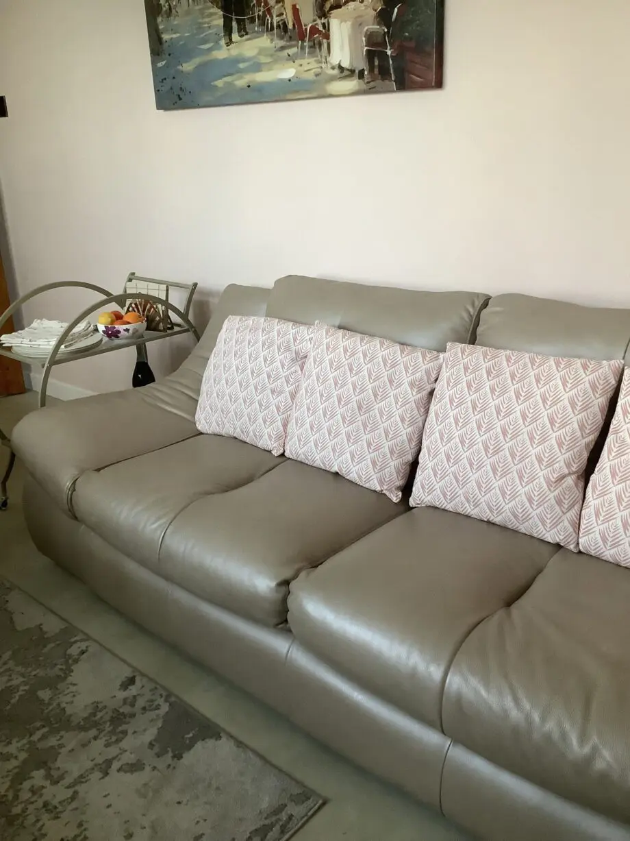 Quality neutral colour leather sofa and matching snuggle chair(Sterling Home)