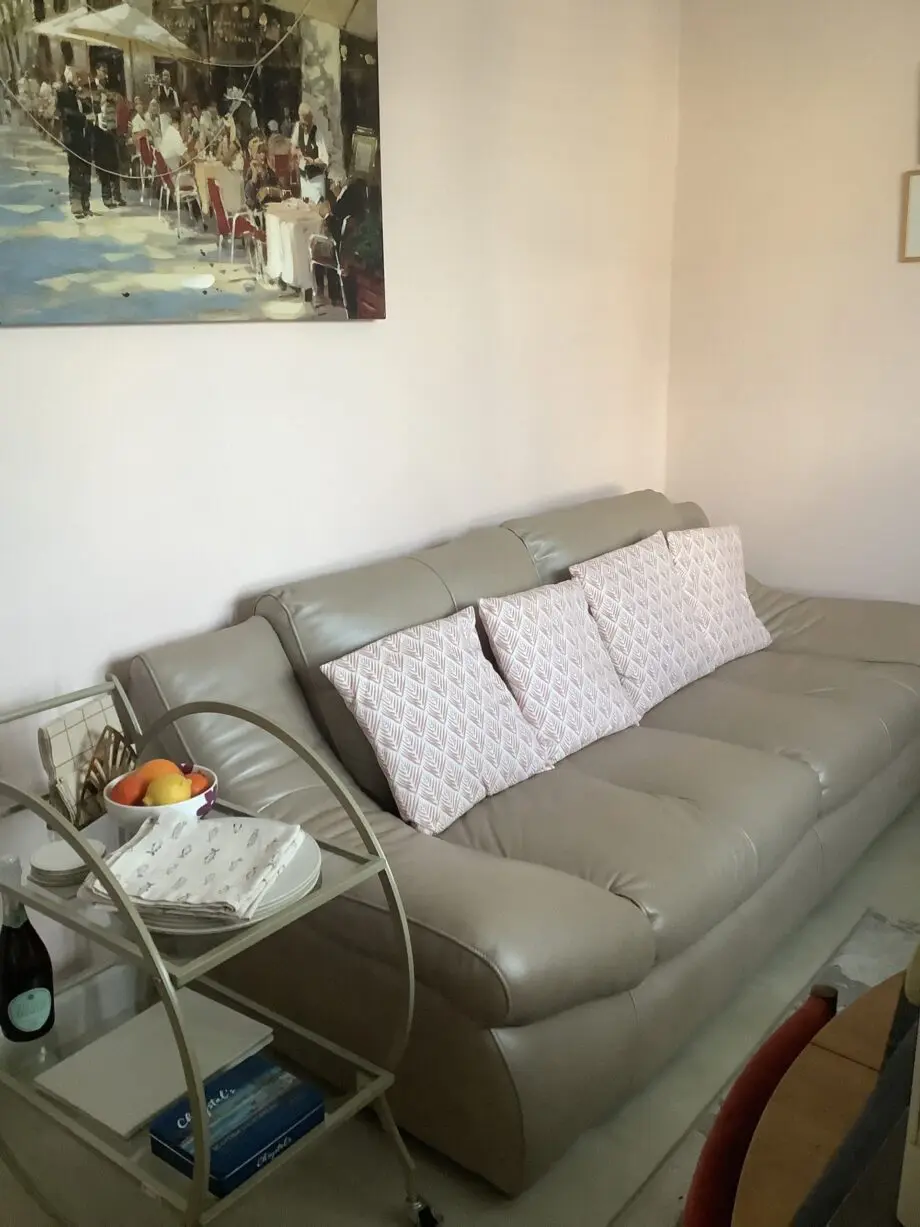 Quality neutral colour leather sofa and matching snuggle chair(Sterling Home)